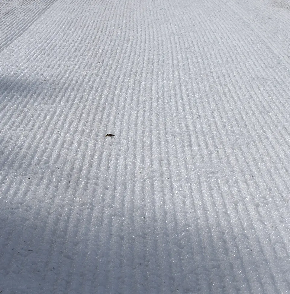 Groomed snow created by a Pisten Bully groomer.