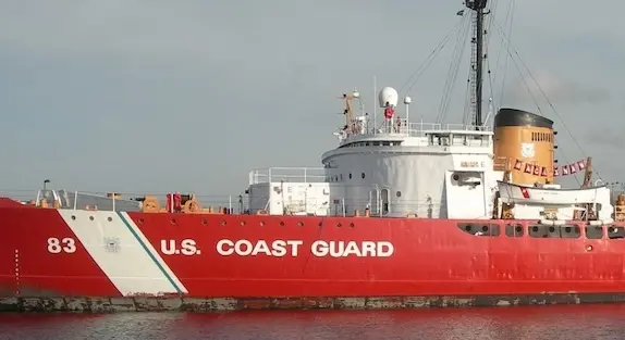 A large red Coast Guard cutter sits docked in Mackinaw City.