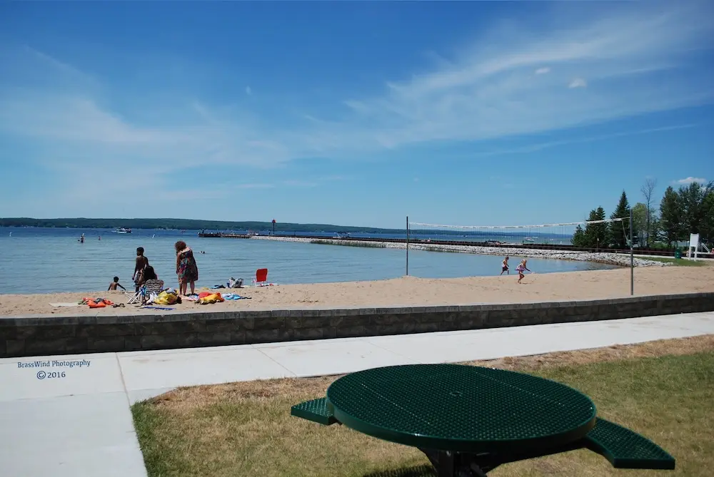Children playing and swimming on a sandy beach