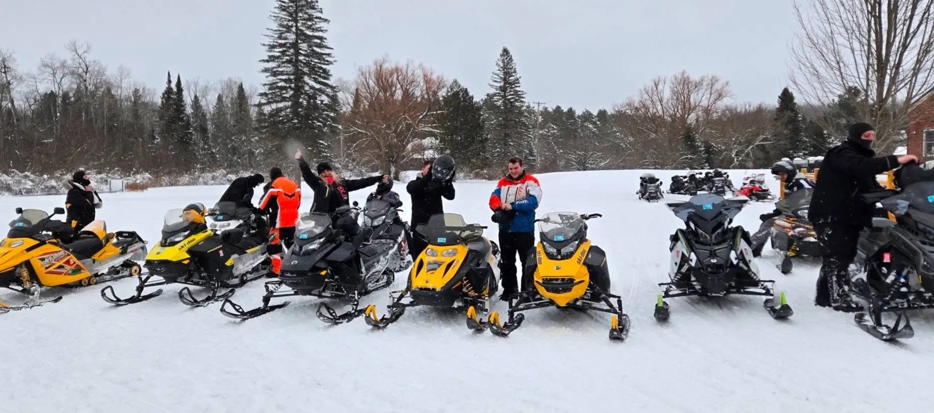 A group of snowmobilers in Indian River, Michigan hitting the groomed trails on their way to Mackinaw City.