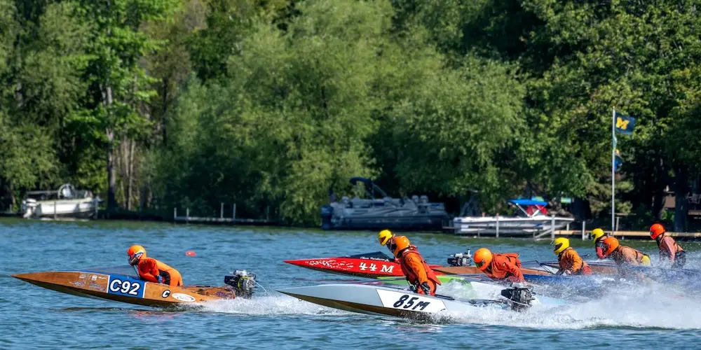 Boats racing in the Top O' Michigan Outboard Nationals Boat Race across Burt Lake.